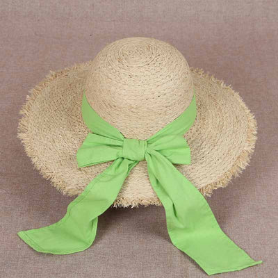 The hat is woven with a bright green ribbon.หมวกสานพันด้วยริบบิ้นสีเขียวสวยสดใส
